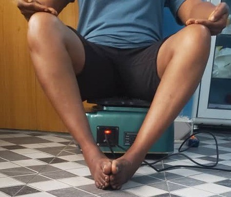 Member sitting comfortably during a supervised blood circulation machine wellness session